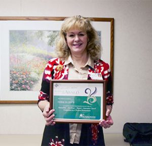 Patricia Linck holding award
